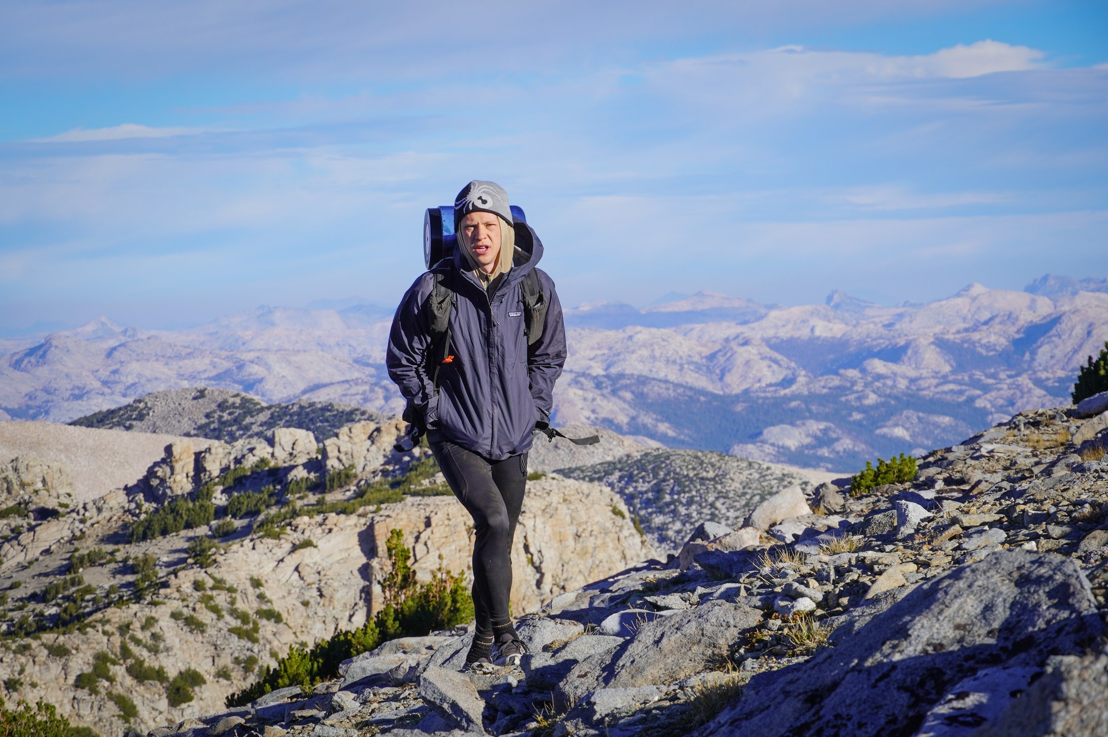 A windy summit with Sierra peaks beyond